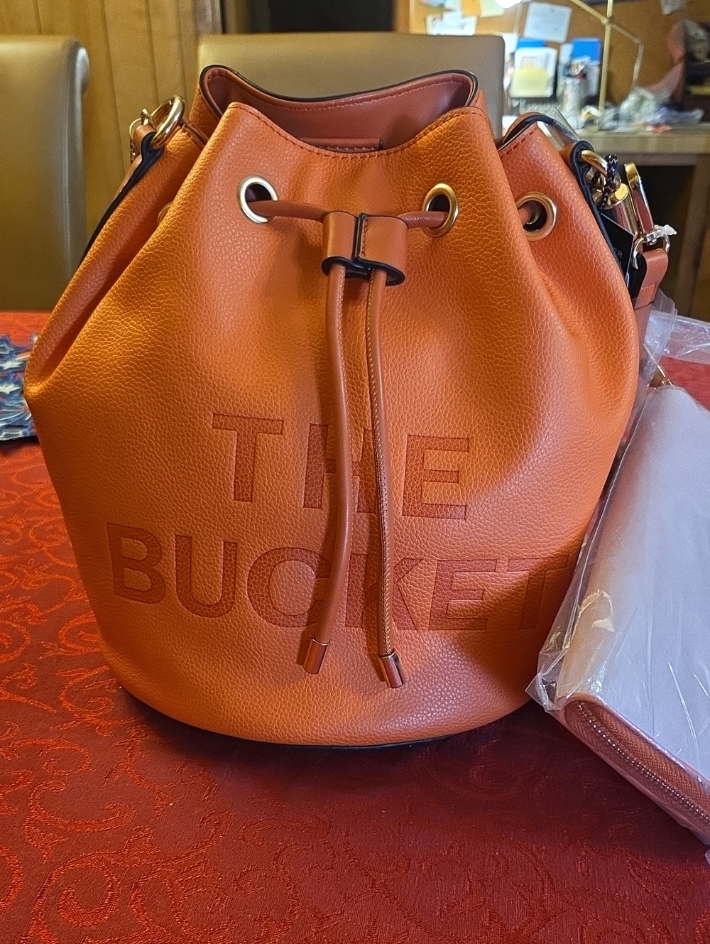 The Bucket Orange Vegan Leather Drawstring Bucket Bag